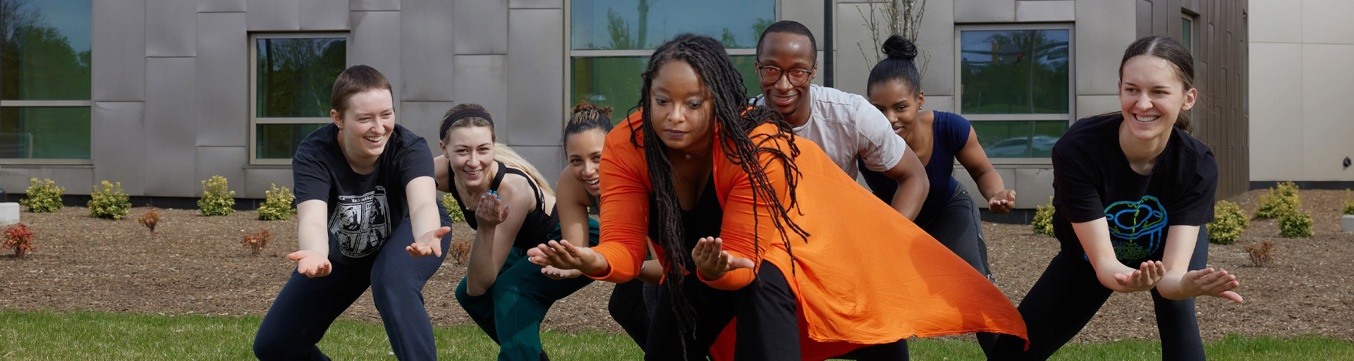dancers posing on grass hero