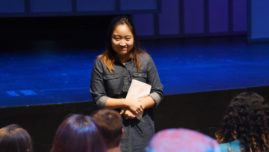 student standing in front of audience